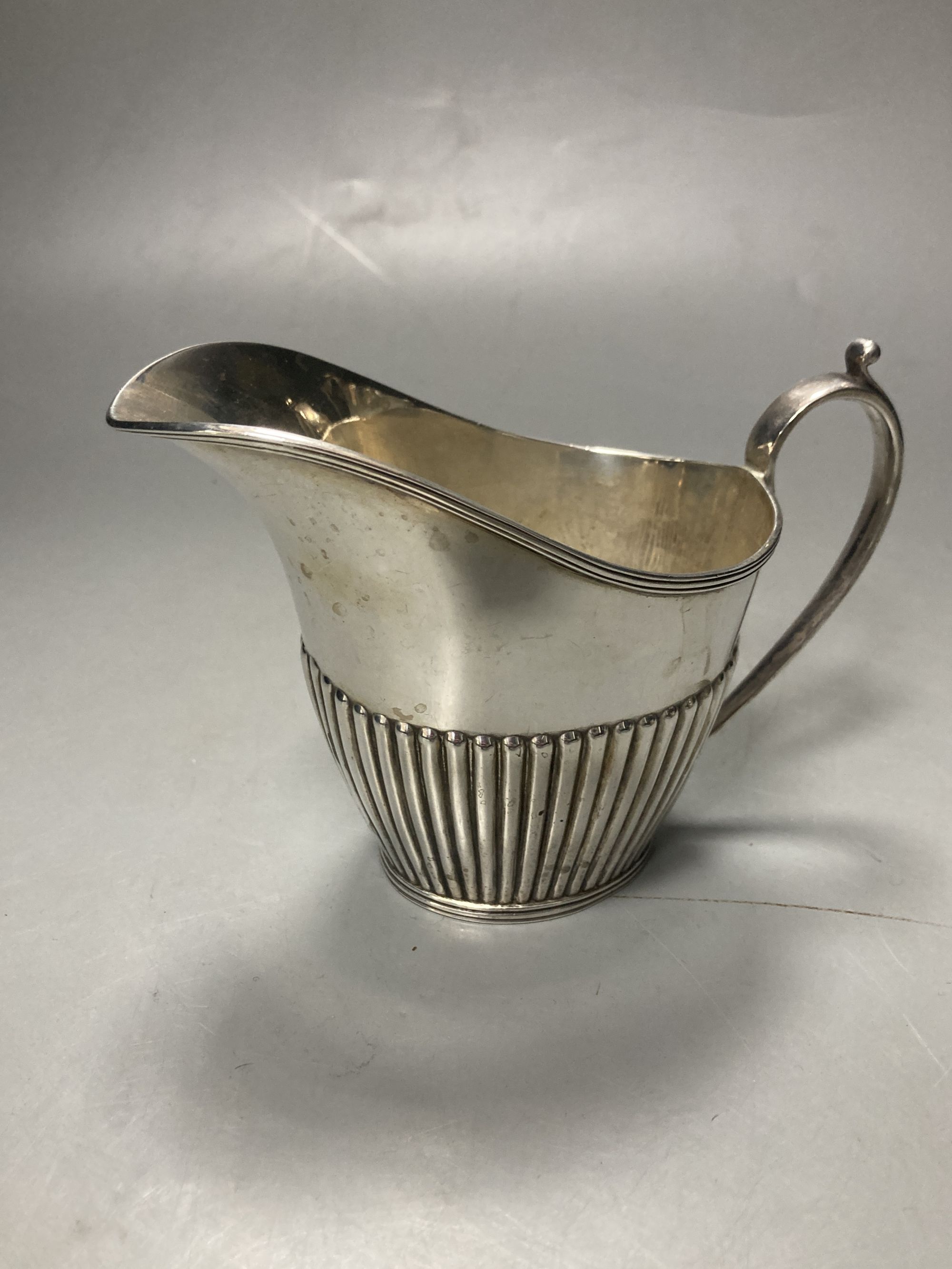 A late Victorian demi fluted silver three piece tea set, Mappin & Webb, Sheffield, 1897 & a matched hot water pot,